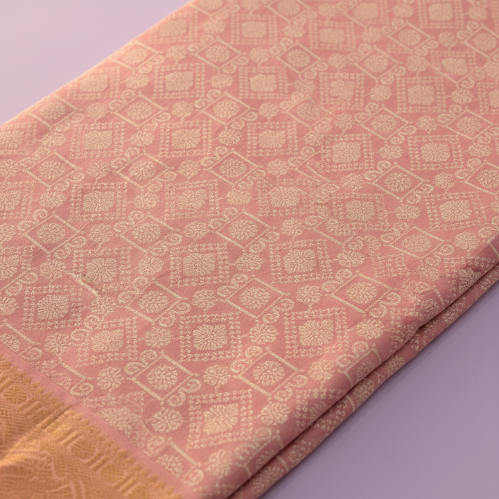 Dusty rose Kanchipuram silk saree body with geometric diamond and floral gold zari jaal close-up