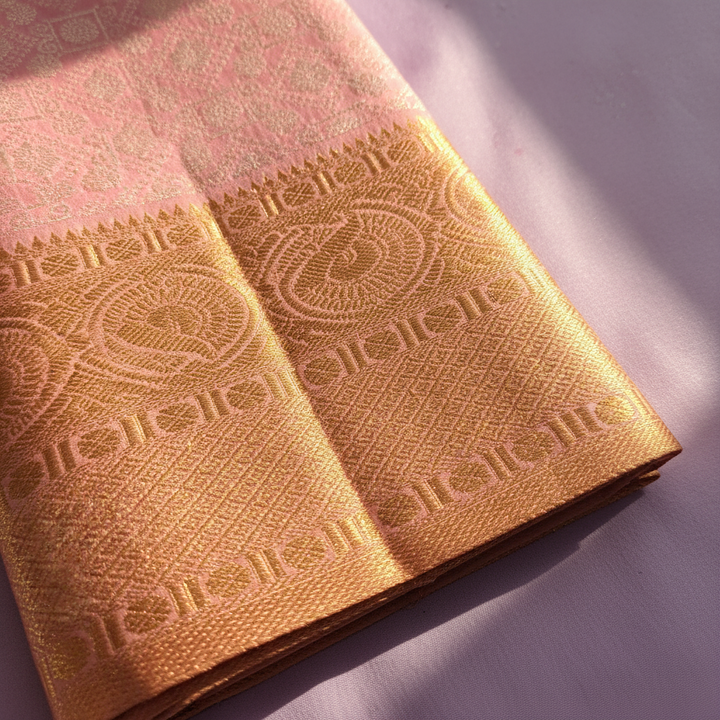 Dusty rose Kanchipuram silk saree gold tissue pallu with peacock and temple motif close-up