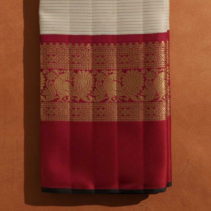 Kuberan  Ivory Cream with All-Over Fine Gold Zari Pinstripe Body & Broad Deep Crimson Red Gold Zari Peacock & Floral Scroll Border Kanchipuram Silk Saree