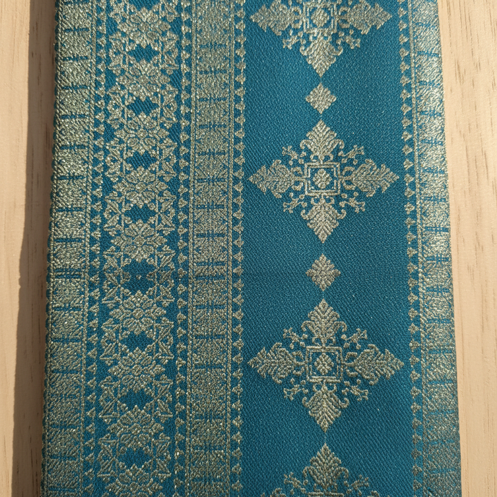Kuberan Peacock Teal with All-Over Silver Zari Dense Geometric Diamond & Snowflake Jaal & Broad Self-Colour Teal Silver Zari Multi-Band Border Kanchipuram Silk Saree