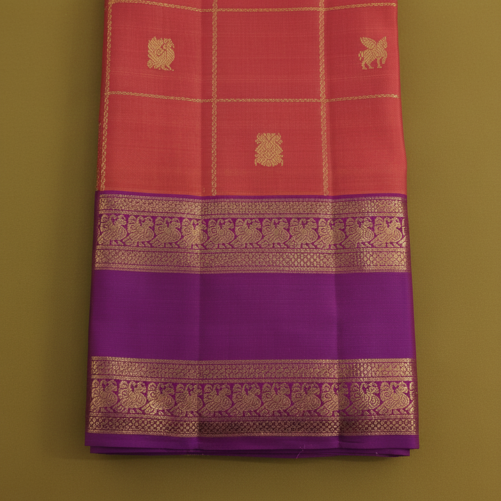 Kuberan  Coral  with Gold Zari Check Grid, Mixed Floral & Bird Buttas & Broad Deep Violet Peacock Procession Border Kanchipuram Silk Saree