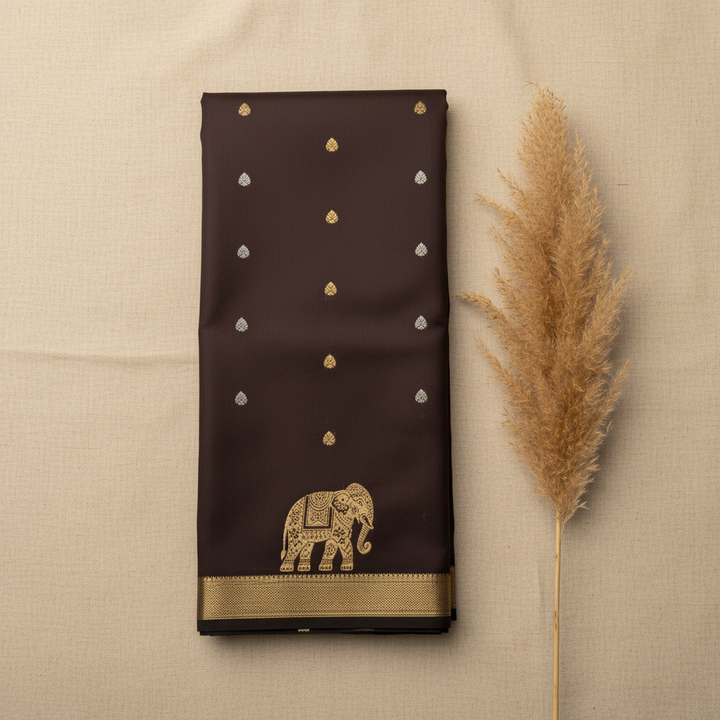 Dark aubergine semi silk saree - editorial flat lay with pampas grass