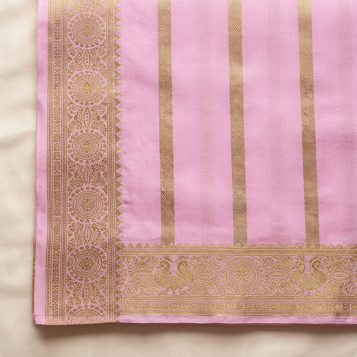Close-up of the light pink contrast section with vertical gold zari woven bands and ornate gold border