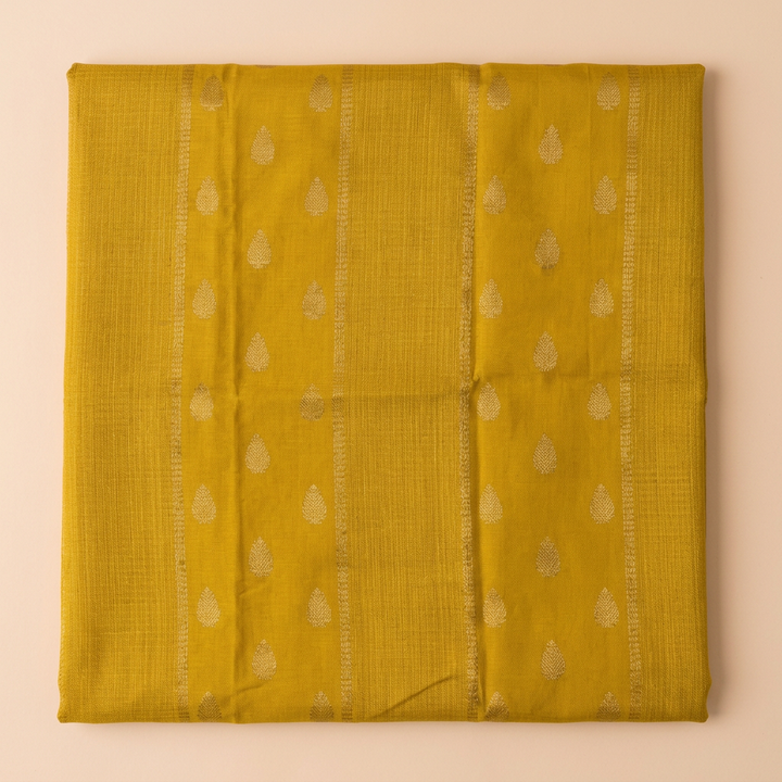 Close-up of the mustard yellow saree body with subtle gold butta motifs