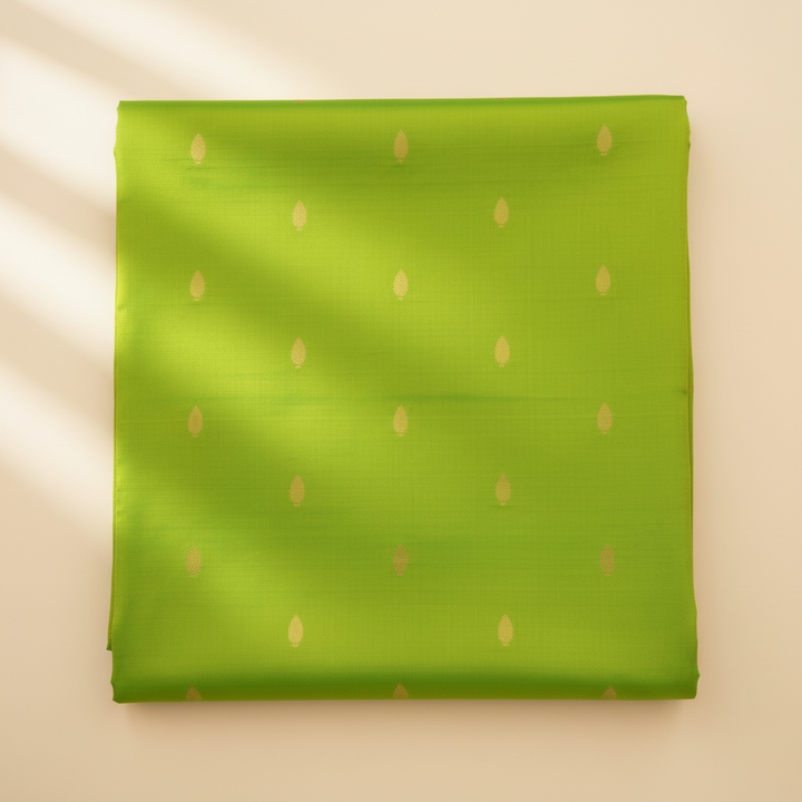 Parrot-green pure silk saree body with gold zari motifs close-up