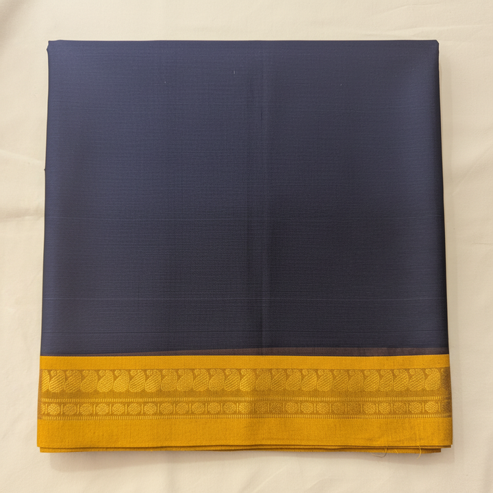 Close-up of the navy-blue saree showing its rich mustard-yellow and antique-gold border with delicate woven motifs and fine horizontal bands