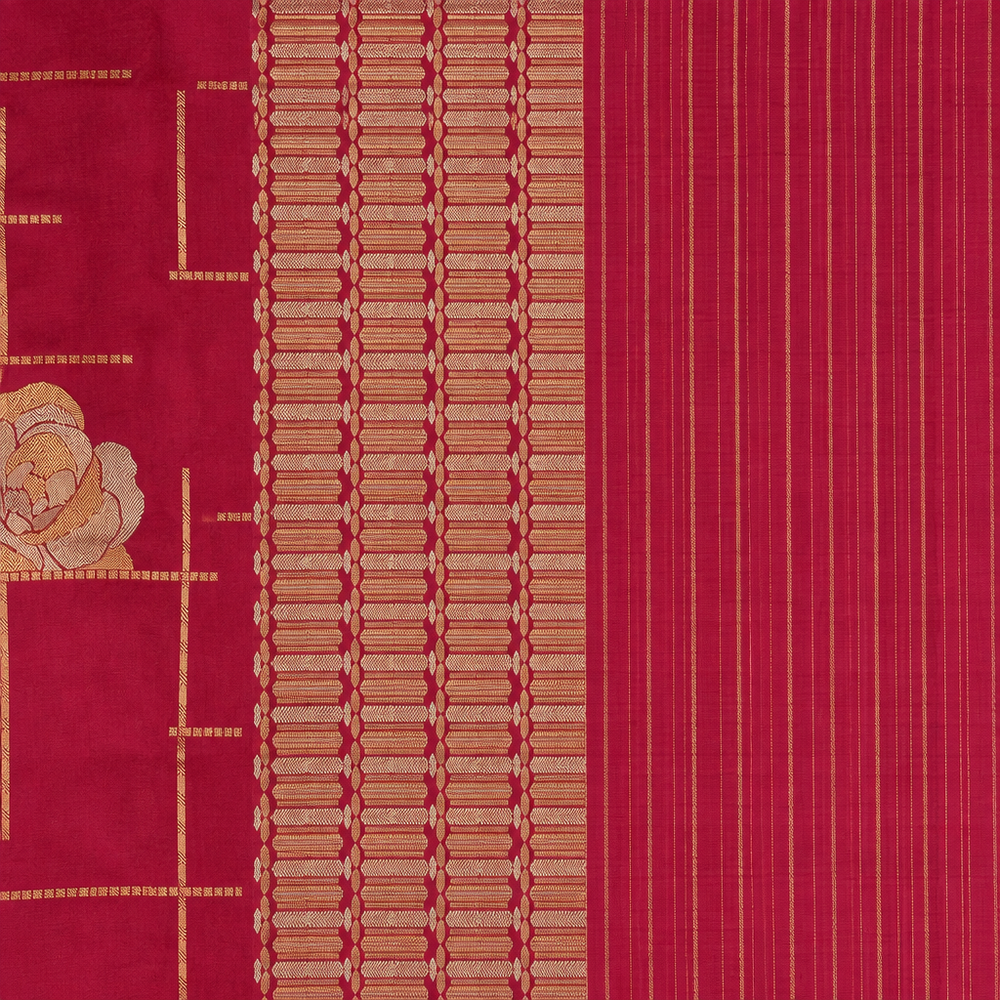 Magenta saree pallu close-up with gold-toned patterned band and fine stripes
