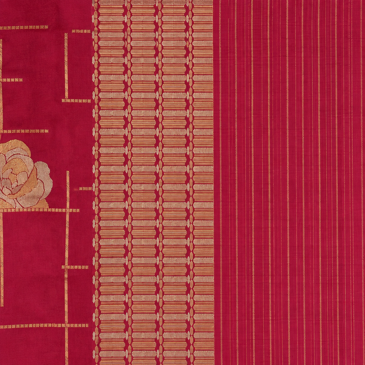 Magenta saree pallu close-up with gold-toned patterned band and fine stripes