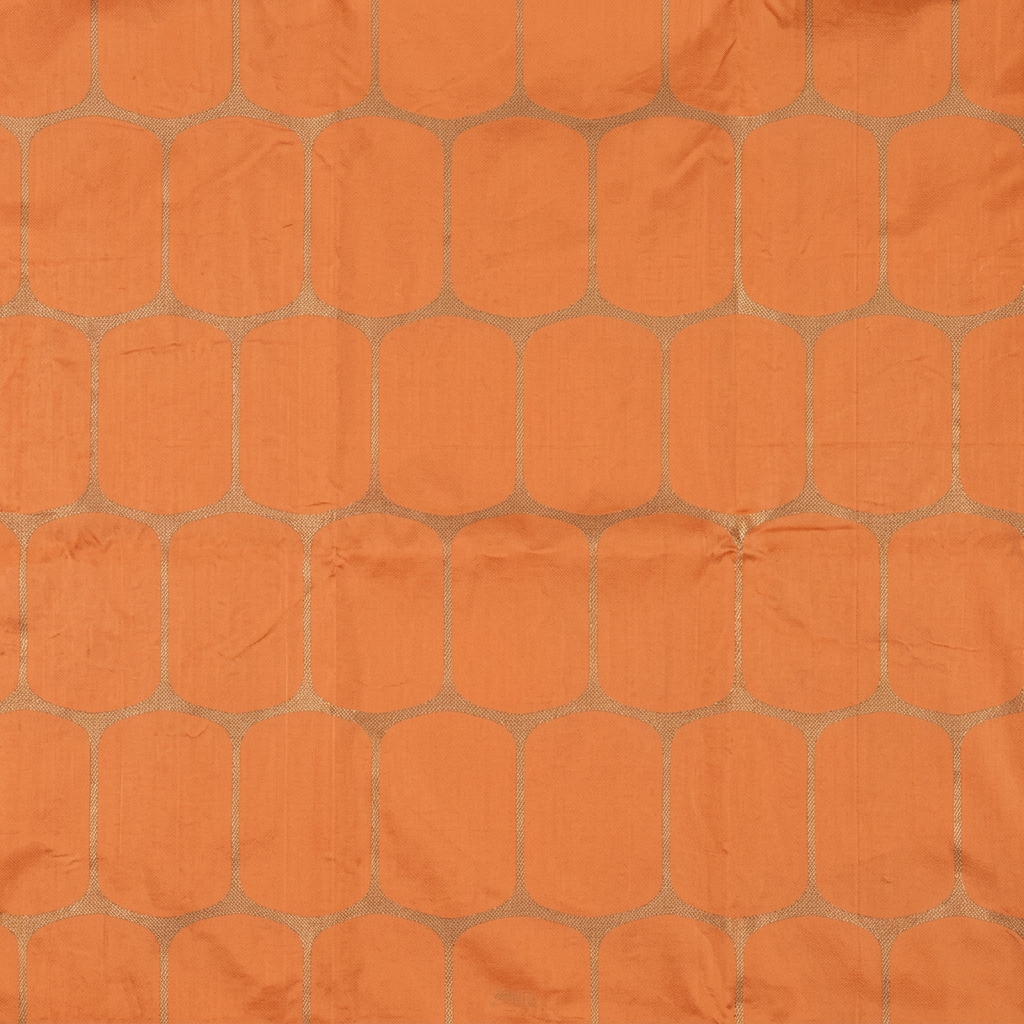 Close-up of rounded metallic-toned lattice checks on peach silk