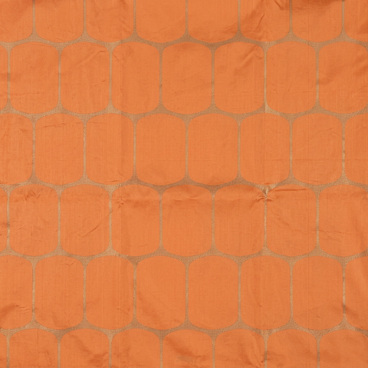 Close-up of rounded metallic-toned lattice checks on peach silk