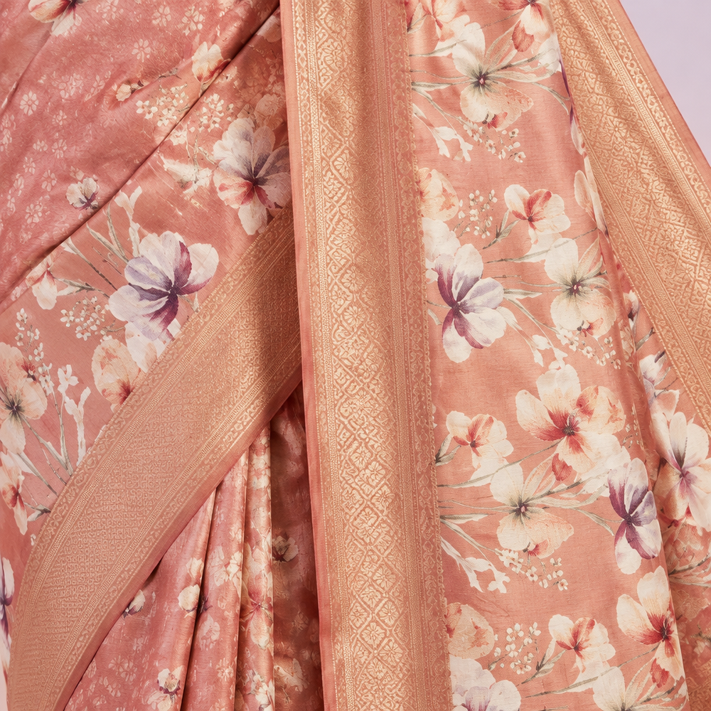 Close-up of the pink pure Tussar silk saree body with white floral prints and golden zari detailing