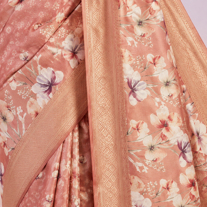 Close-up of the pink pure Tussar silk saree body with white floral prints and golden zari detailing