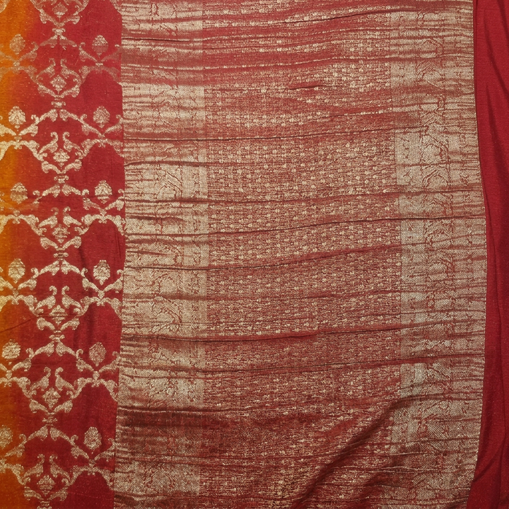 Close-up of red and copper-gold-toned pallu with horizontal woven detailing