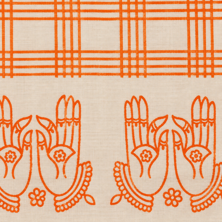 Close-up of orange hand-mudra print border on cream cotton dance saree