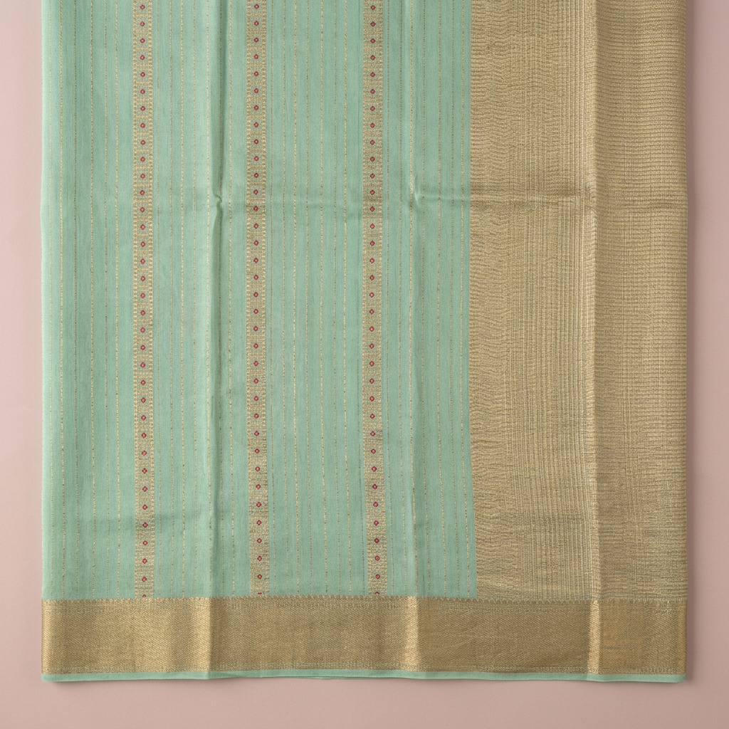 Close-up of the beige-gold woven section with fine zari bands and the gold woven border