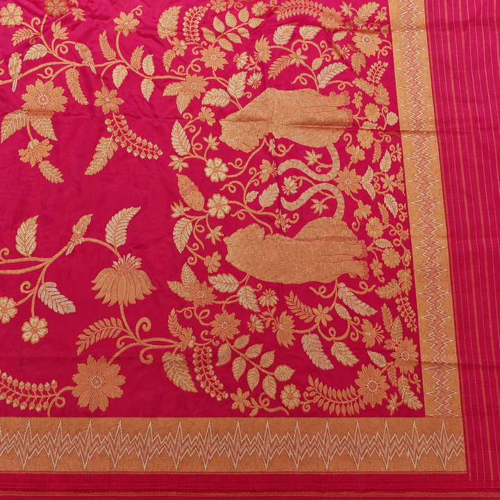 Pink saree pallu with gold-toned botanical motifs, zigzag borders and a fine striped end section