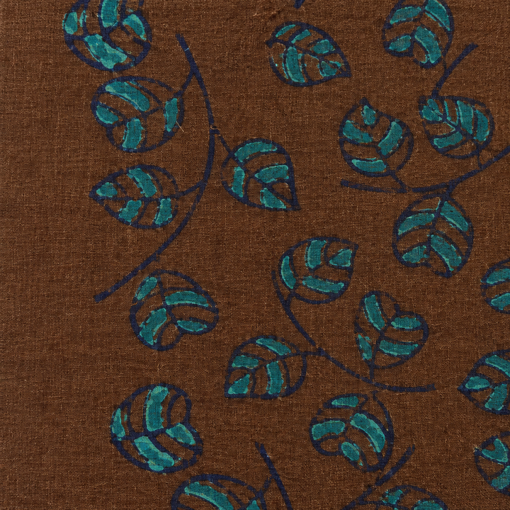 Close-up of teal leaf vine print on brown cotton saree