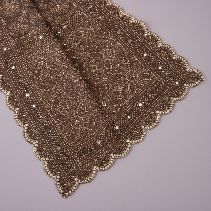 Close-up of the brown pure satin crepe silk saree scalloped border and detailed pallu finish