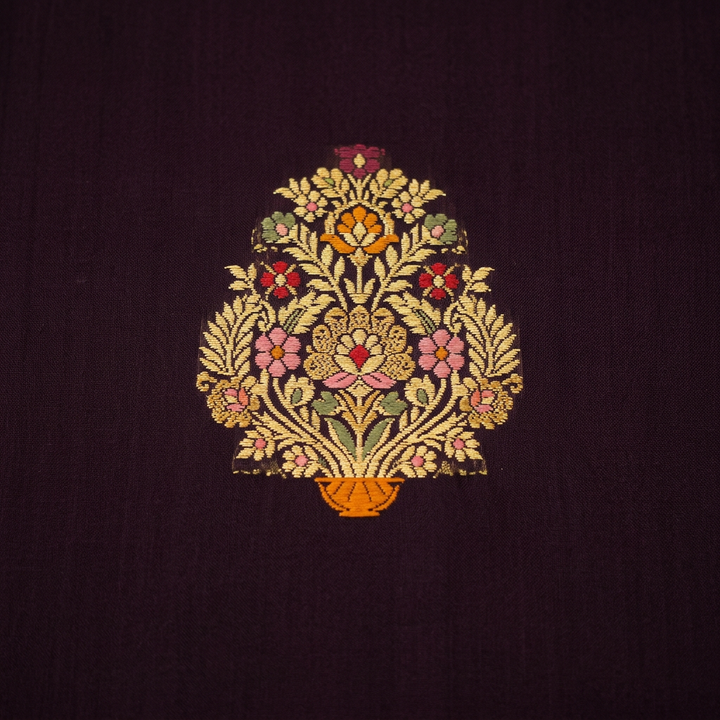 Close-up of ornate gold-toned floral motif with multicoloured accents