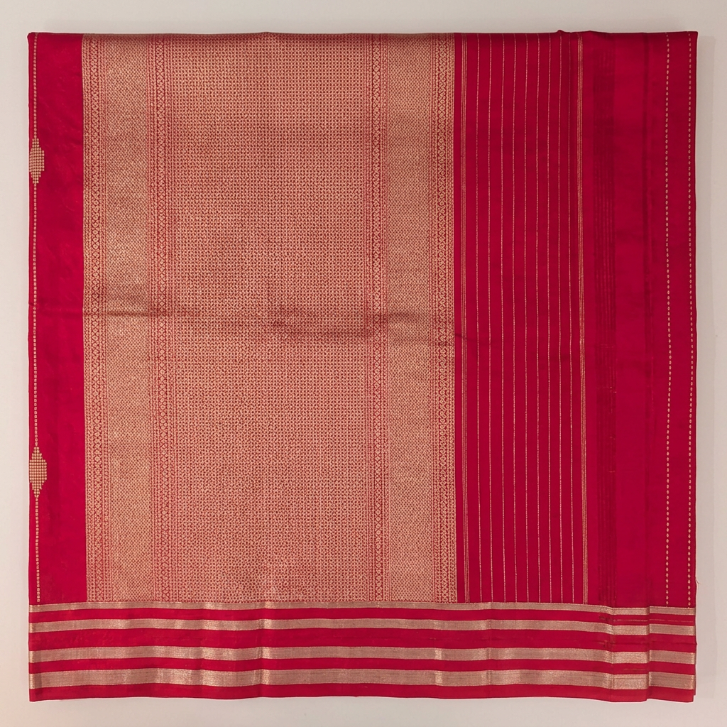 Close-up of gold-toned patterned pallu, striped pink end and parallel metallic-toned border bands