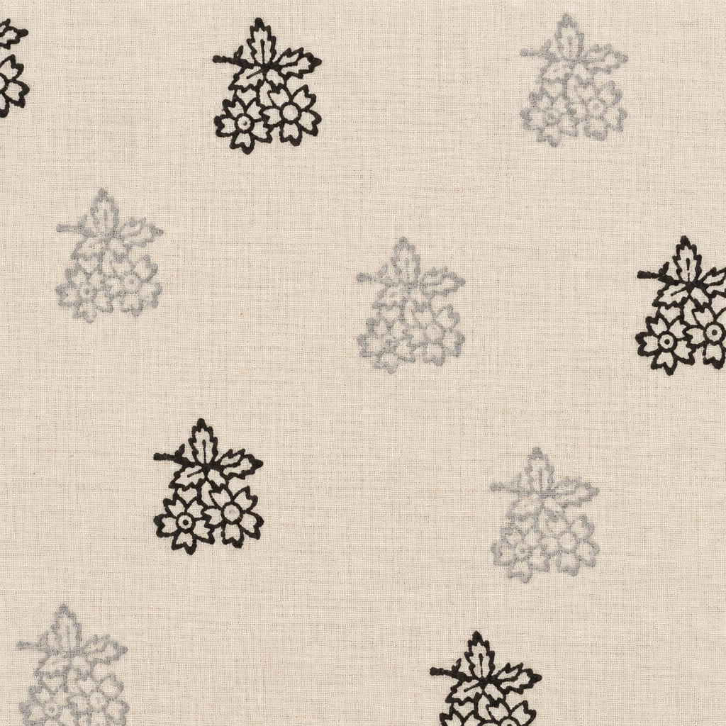 Close-up of black floral buta on cream cotton saree body