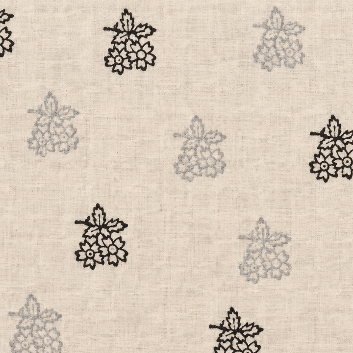 Close-up of black floral buta on cream cotton saree body