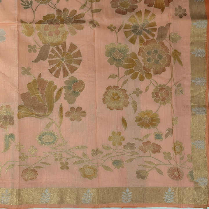 Close-up of larger multitone floral pallu and gold-toned border with pale motifs and peach edging