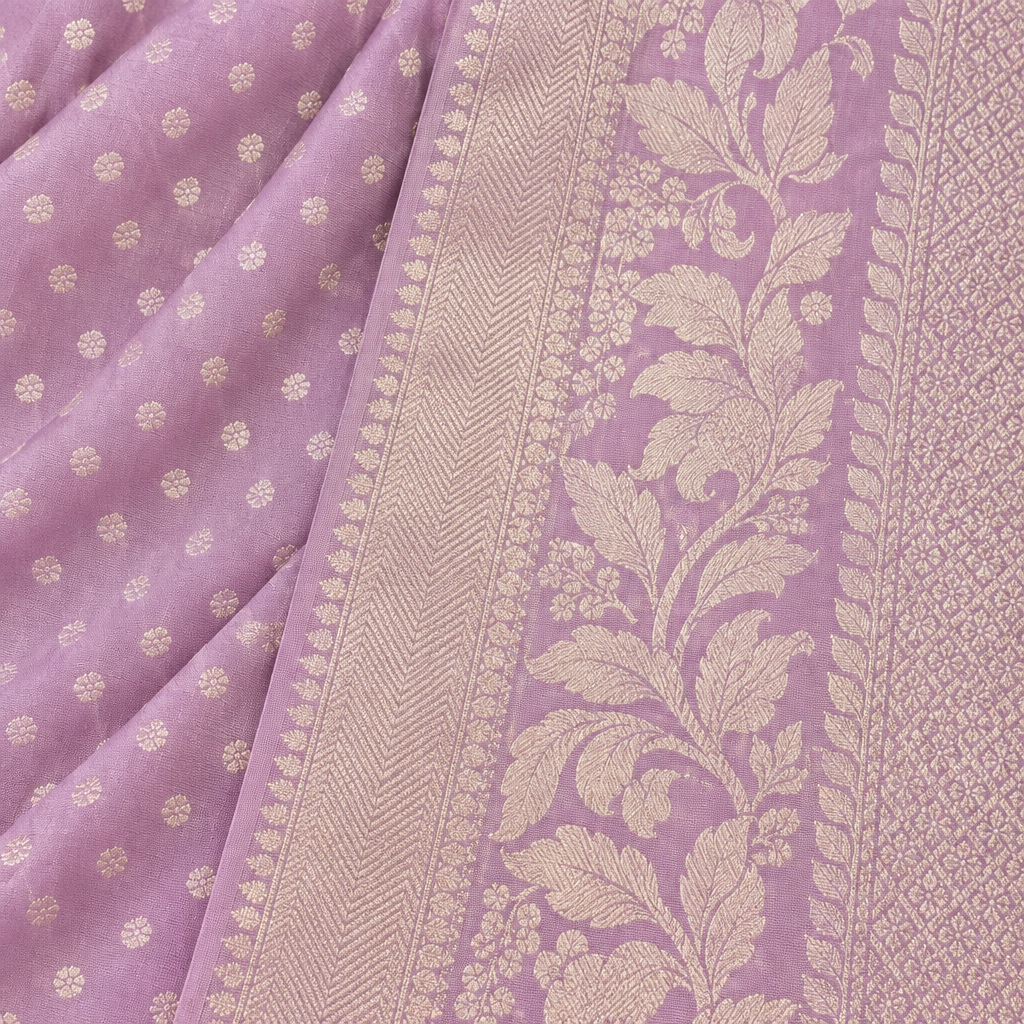 Close-up of the lavender saree's woven silver zari border and pallu with leaf-and-vine motifs