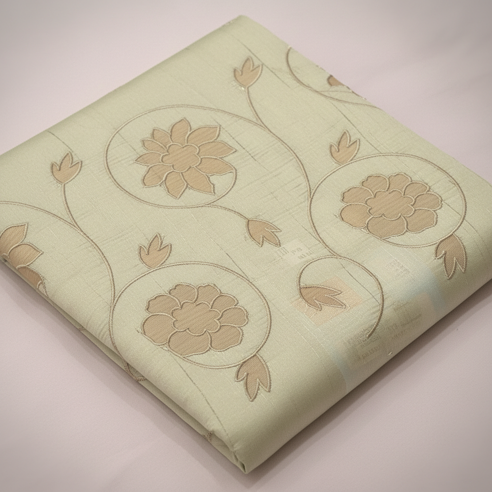 Close-up of the pastel green cotton saree floral motifs