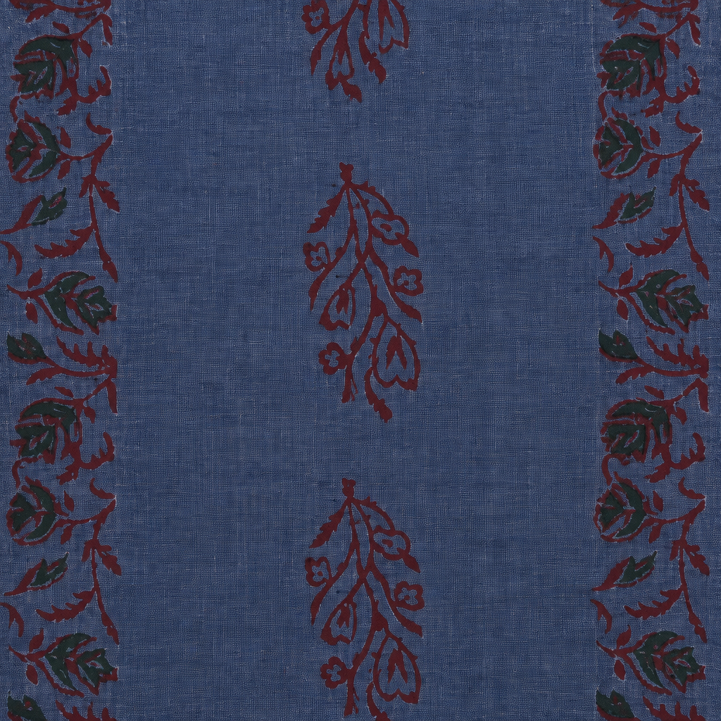 Close-up of maroon floral vine print on blue cotton saree body