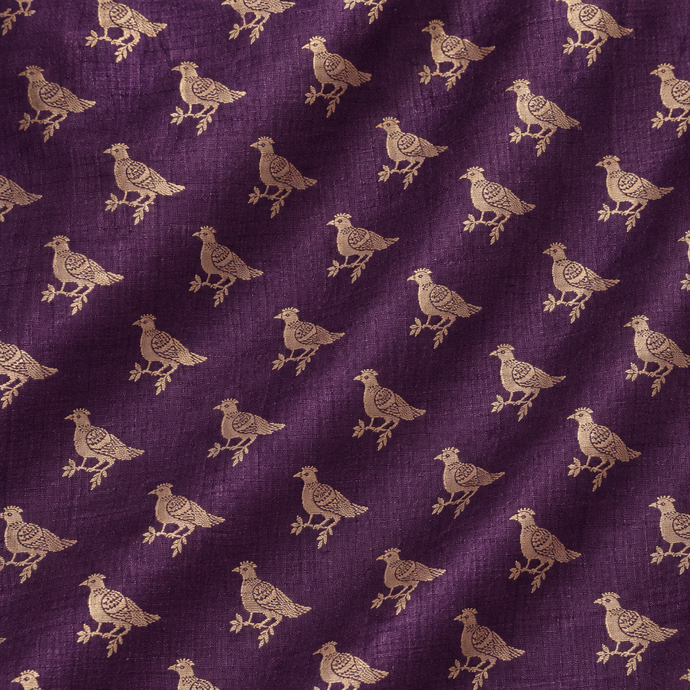 Close-up of the purple pure Tussar silk saree body with gold zari bird motifs