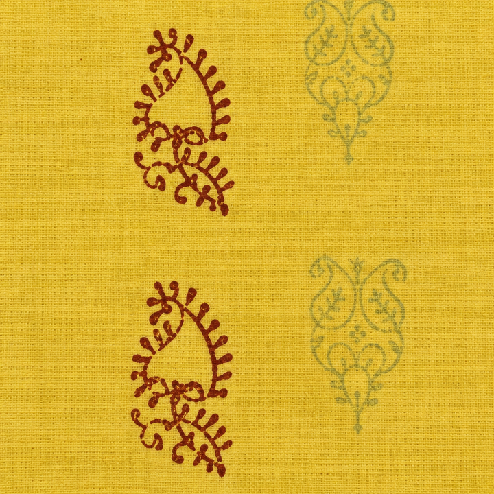 Close-up of rust paisley buta on lemon yellow cotton saree body