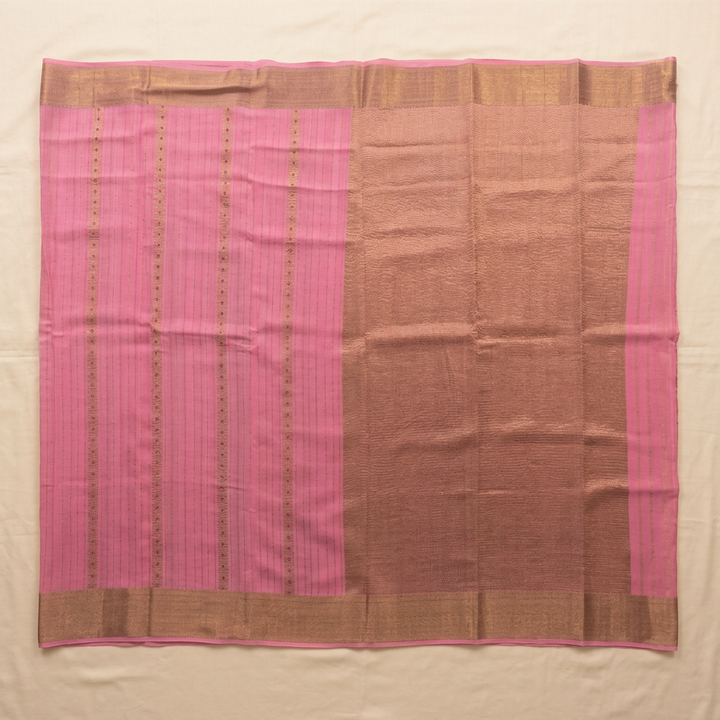 Upstraight overhead view of a light pink pure Mysore crepe silk saree with gold dot rows, a coppery-brown zari-woven section and gold border