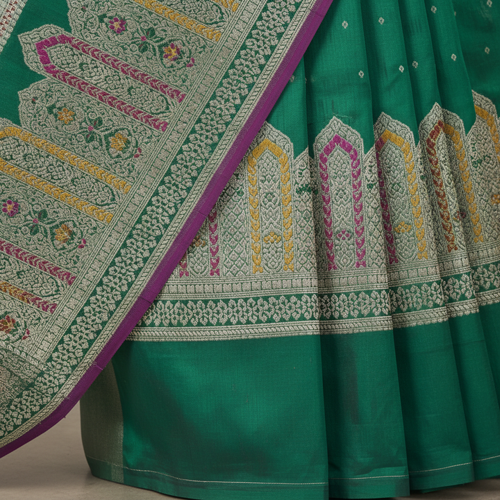 Close-up of the dark green Banarasi silk saree silver-gold woven pallu and multicolour border accents