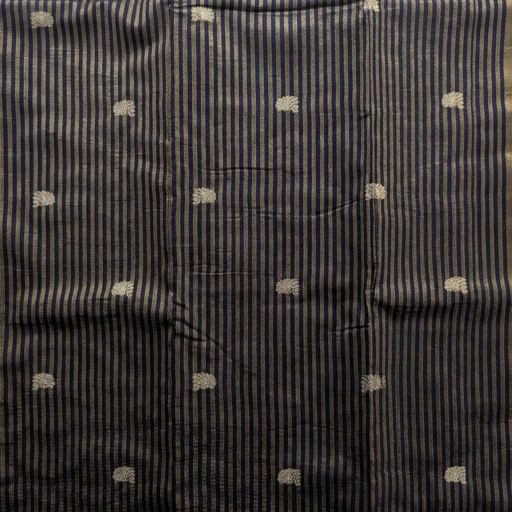 Close-up of navy-blue saree body with fine gold-toned stripes and small butta motifs
