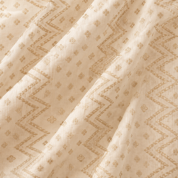 Close-up of the white Banaras georgette saree body with self-tone chevron and butti motifs