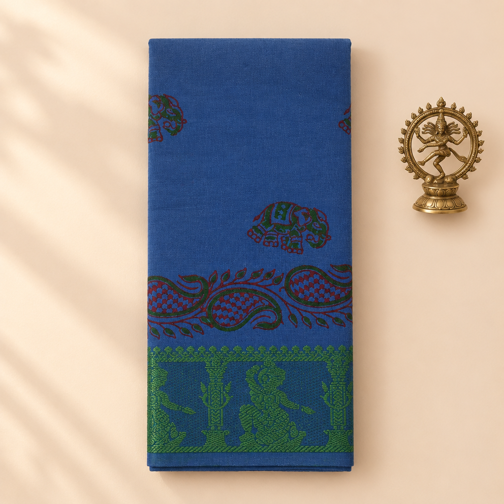 Royal blue cotton dance saree with paisley print and green border, folded flat lay with Nataraja prop