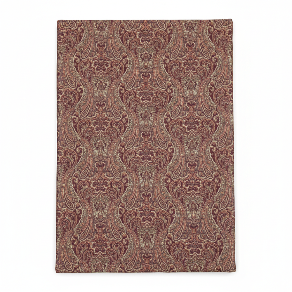 Close-up detail of rose-gold brocade fabric with paisley pattern