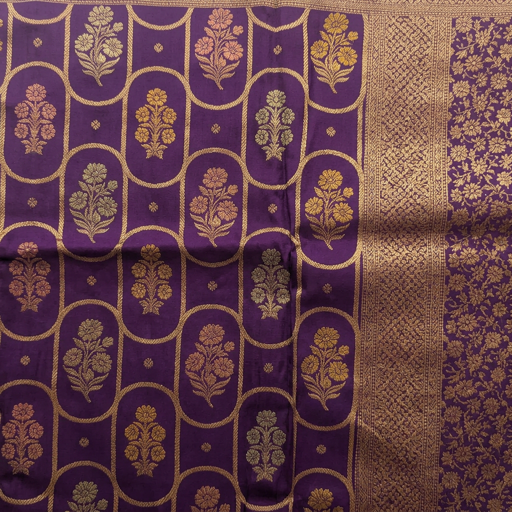 Close-up of purple saree floral body motifs within a gold-toned curved lattice