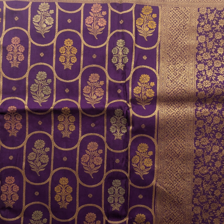 Close-up of purple saree floral body motifs within a gold-toned curved lattice