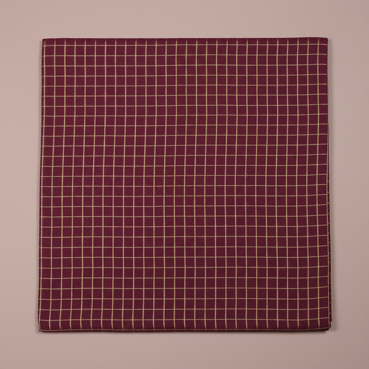 Close-up of the burgundy, wine, and plum cotton saree with its fine pale-gold checked grid