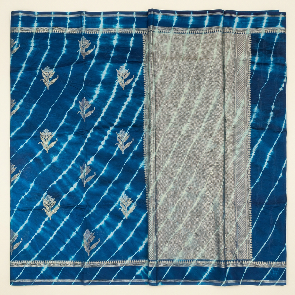 Full straight view of blue Leheriya silk saree with floral motifs and broad metallic-toned pallu