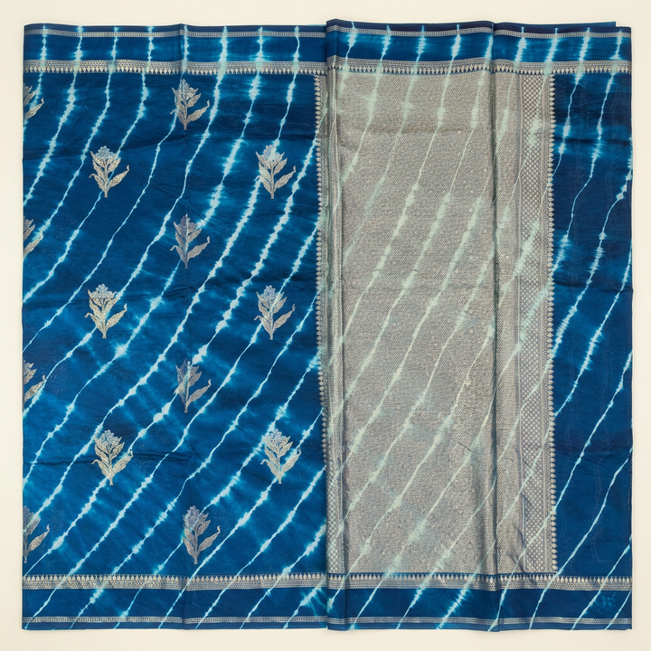 Full straight view of blue Leheriya silk saree with floral motifs and broad metallic-toned pallu