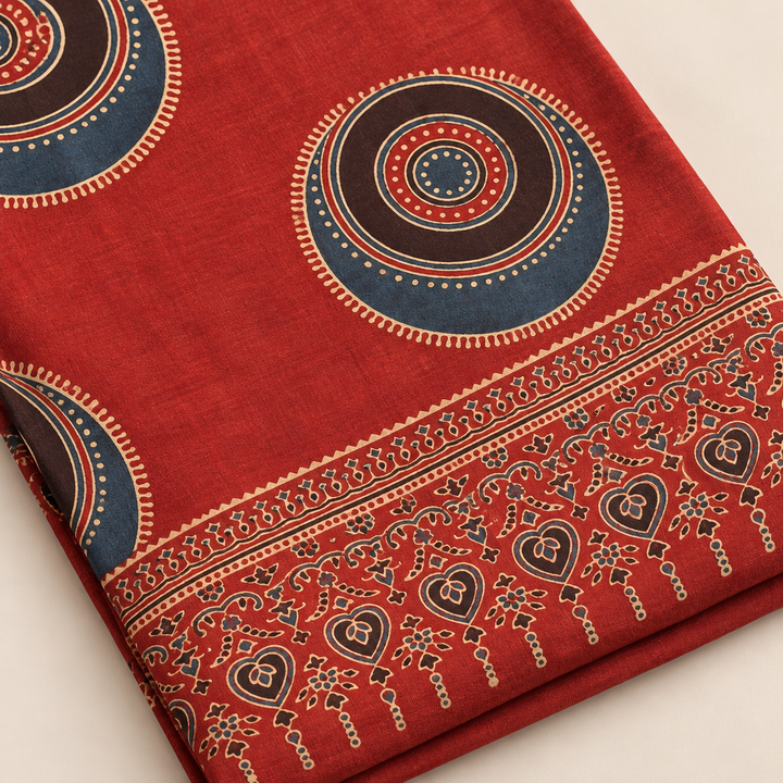 Close-up of red Ajrakh saree print, texture and folded edge