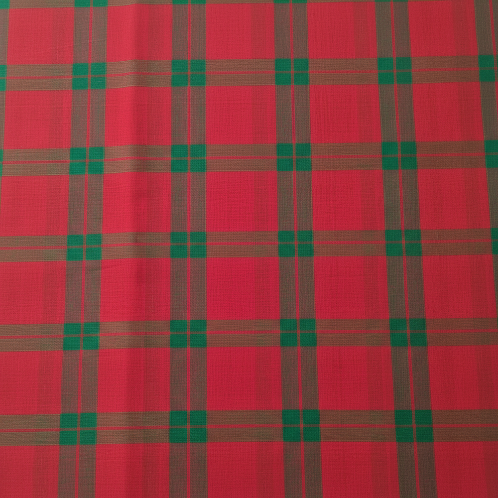 Close-up of the pink and crimson cotton saree showing its dark olive and emerald-green checked plaid grid