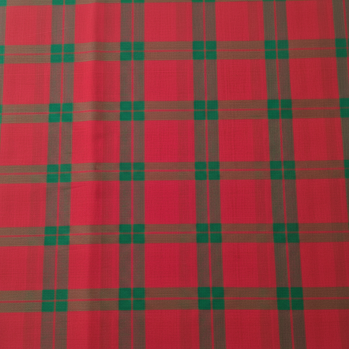 Close-up of the pink and crimson cotton saree showing its dark olive and emerald-green checked plaid grid