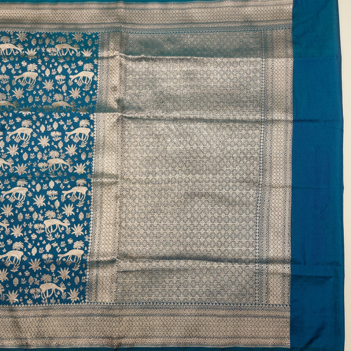 Close-up of metallic geometric lattice pallu and patterned border on blue semi Banarasi saree