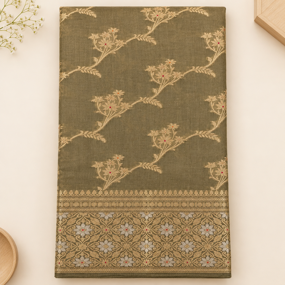 Close-up of gold floral vines on olive green Tussar silk saree