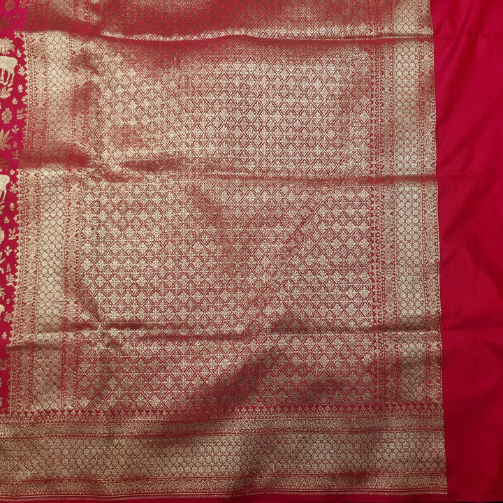 Close-up of metallic geometric lattice pallu and patterned border beside plain pink panel