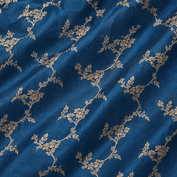 Close-up of the blue pure Tussar silk saree body with zari floral vine motifs